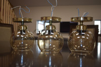 3 Gold  and champagne tinted glass light fixtures