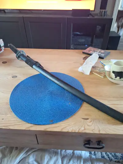 A replica samri sword for decorative purposes only. Lost the end piece but the sheth is wooden and t...