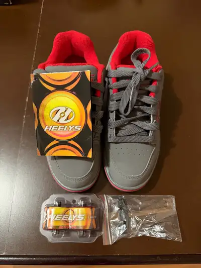 I'm selling a pair of brand new Heelys, size US Youth 3, in gray and red, perfect for some rolling f...