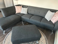 Small modern sofa with attached chase and separate Ottoman
