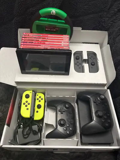 Nintendo Switch, With many controllers, accessories, 10+ games, View more