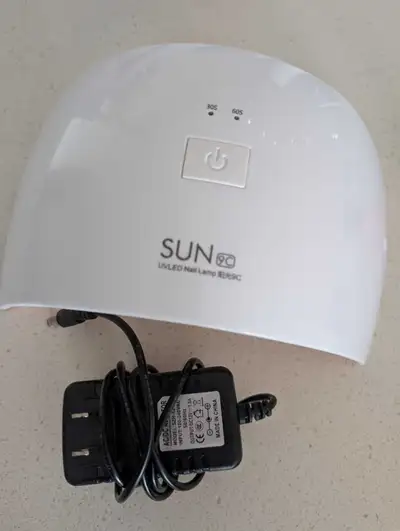 Gel nail kit with UV lamp, gel base and top coats, and gloves to protect hands from UV lights (leave...