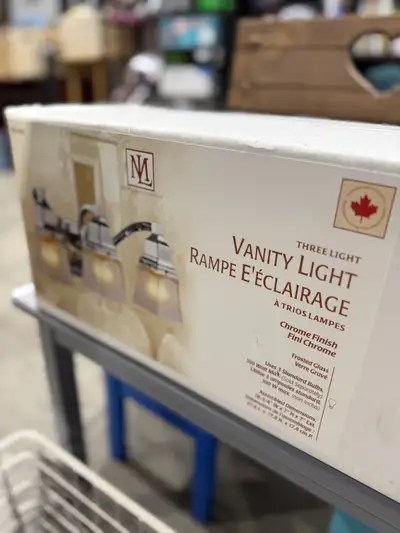 Illuminate your bathroom with this new Minka Group three-light vanity fixture, featuring a chrome fi...