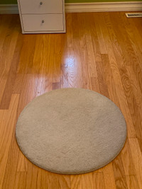 Small circular rug from IKEA ; off white.