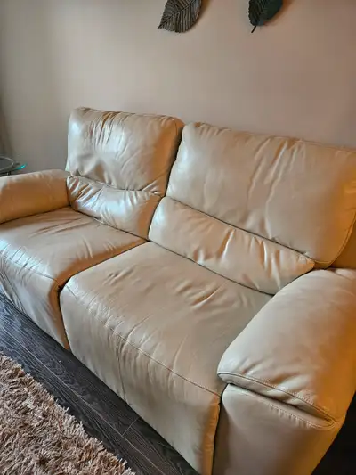 Cream colored reclining leather sofa. Operates good. Very comfortable. Selling low price because one...