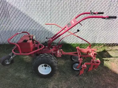 Troy- Bilt rototiller/ pull tractor as shown. Comes with four different attachments as shown in pict...