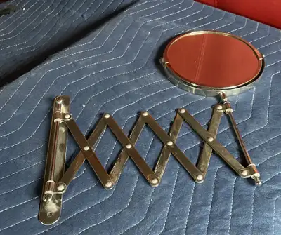 Chrome mirror that pivots from normal to 5X on extendable arm, wall hung, 6.5”w x 15”h, $ 15.
