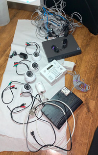 Surveillance cameras with a receiver and digital alarm panel.
