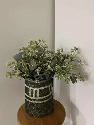 Beautiful decorative woven basket with artificial greenery/flowers. Selling the basket and flowers t...