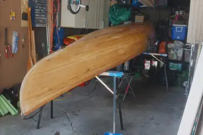 A hand-built cedar strip Prospector with fibreglass over a wood core — the classic Canadian canoe in...