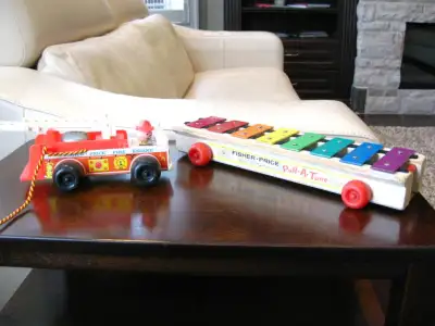 I have two Vintage Fisher Price toys for sale. One is a Vintage Fisher Price Fire Engine Truck and t...