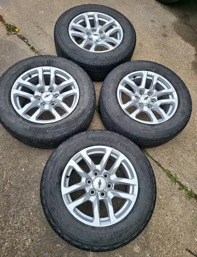 Set of 2020 Chevy OEM truck 18 inch rims and tires the rims have no scuffs or damage tires are Goody...