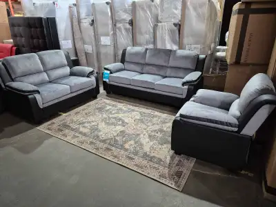This brand new 3pc sofa set features a modern design with plush, grey microfiber cushions and sleek,...