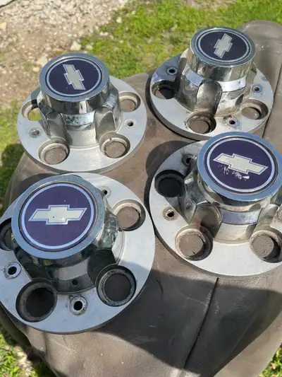 Chevy center hubs excellent shape only 4 no holds .