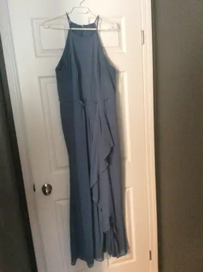 Bridesmaid dress for sale. Size 18. Colour is stormy blue. Mid slit on left leg. High neck and back....