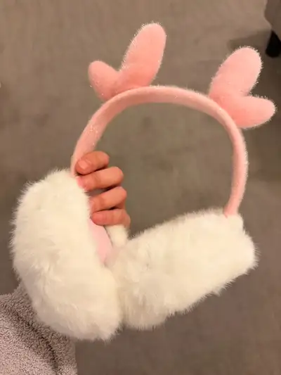Keep your ears cozy and stylish with these adorable pink and white earmuffs! They are in good condit...
