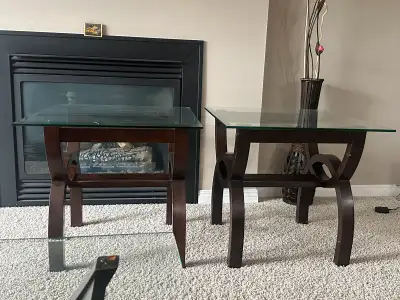 Selling a pair of stylish and sturdy end tables with glass tops and dark wood bases. These matching...