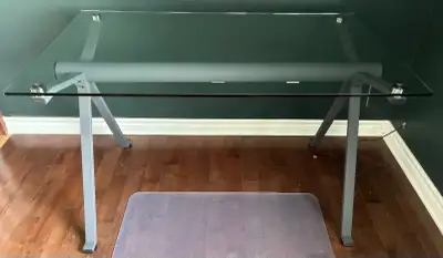 Sturdy contemporary design. Tempered glass top with dark grey steel legs. Dimensions: ~ 48” W x 28.5...