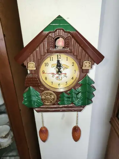 Vintage plastic imitation cuckoo wall clock, no pendulum but works fine, battery operated , measures...
