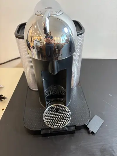 Brew café-quality coffee and espresso with this reliable Nespresso Vertuo machine, which is in good...