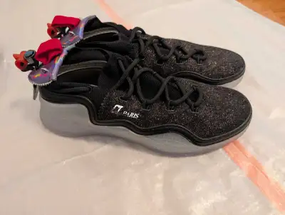 Step out in style with these used Christian Louboutin sneakers, showcasing a sparkling black glitter...