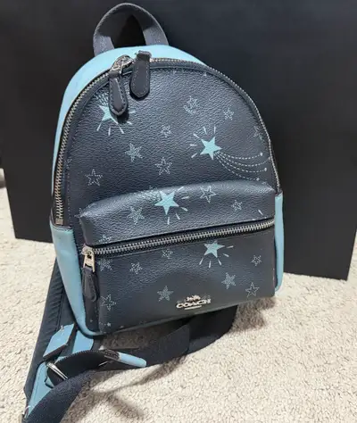 This is a stylish, previously owned Coach small backpack, perfect for adding a touch of flair to you...