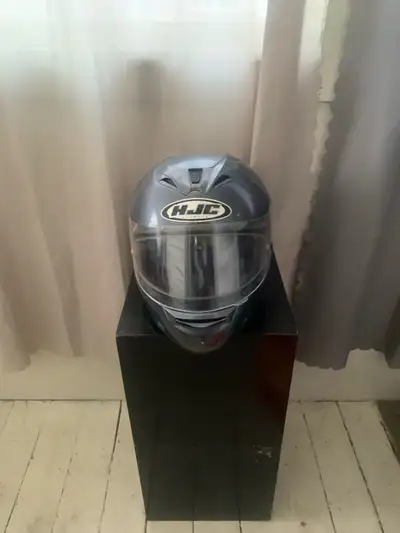 This is a used HJC helmet designed to provide safety and comfort on the road. The helmet has some sc...
