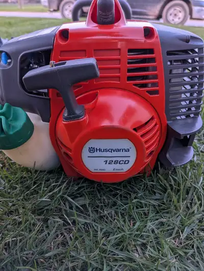 Husqvarna trimmer with attachments.  like new, View more