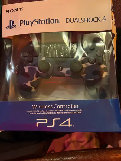 This brand new Sony PlayStation DualShock 4 Wireless Controller in an eye-catching blue camouflage f...