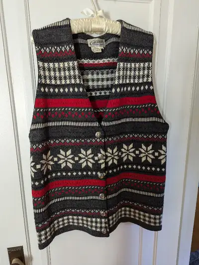Sweater vest in cream, gray and red Nordic-style designs. Has been worn a few times, but is in good...