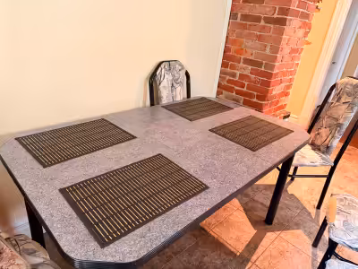 A dinnig table in a good condition with 6 chairs,4 of them are ribbed front as shown in picture.Reas...