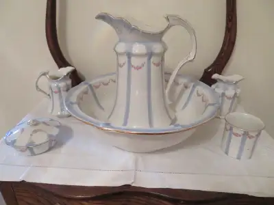 ANTIQUE WASH SET AND STAND -I have an antique Wash Stand Set of 7 pieces and 2 lids. It is made by t...
