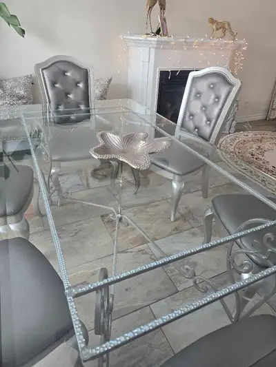 Elegant dining table features a heavy, forged metal base , View more