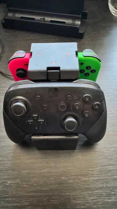Switch Pro Controllers with charging dock and a set of Joycons, View more