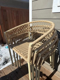 4 rattan look all weather material patio chairs with cushions.