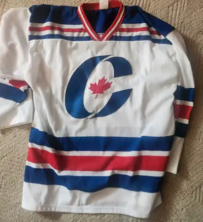 Show your Canadian pride with this unique hockey jersey, featuring a bold 'C' with a maple leaf embl...