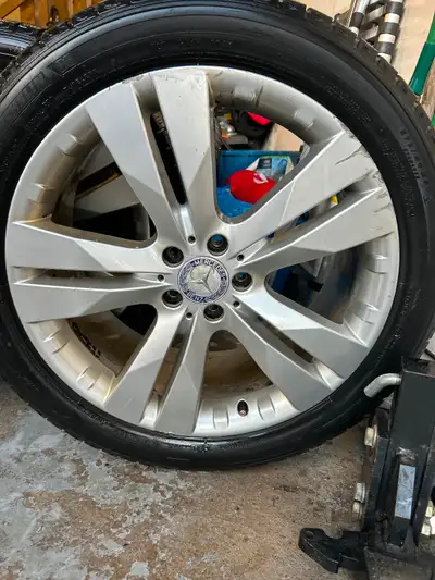 The 20-inch OEM Mercedes Benz rims, originally from a 2017 GL, show some signs of wear. They come eq...