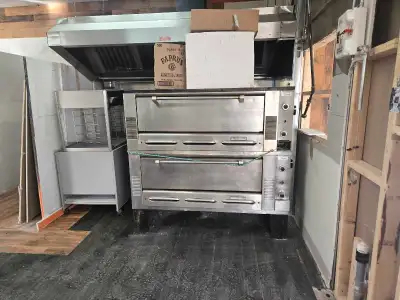 Garland stone pizza ovens stones in perfect condition, Large box of pizza pans, 2 paddles and a rock...