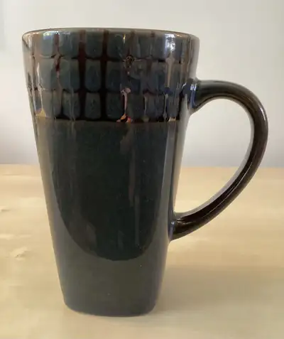 This 16-ounce stoneware mug from Roscher is microwave and dishwasher safe. It stands 5 7/8" tall and...