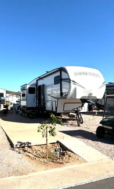 This pre-owned Forest River Impression fifth wheel offers a spacious layout, perfect for your next f...