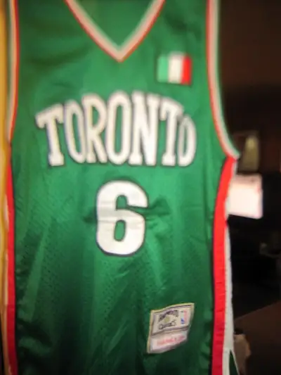 Selling a rare collectible vintage Toronto Raptors basketball team jersey green color now retired nu...