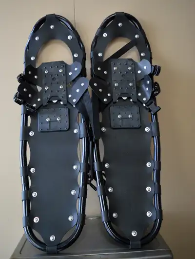 Black No Brand Snowshoes with Carrying Case Can carry up to 240 lbs. and accomodate up to Size 13 Bo...