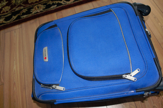 Delsey carry on luggage on 4 wheels with handle and front pocket in Other in North Bay - Image 2