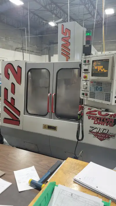 USED CNC VERTICAL MACHINING CENTER MAKE HAAS MODEL VF-2 YEAR 1998 LOW HOURS EQUIPPED WITH 4 AXIS ROT...