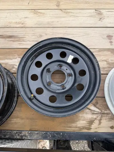 Rims 15”x6 5 rims 4 black 1 white Bolt pattern 5x127 0 off set 84.0 center bore
