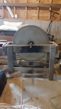 Antique Grinding Wheel Standing on Wooden Base