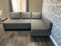 Corner sofa-bed with storage, dark grey