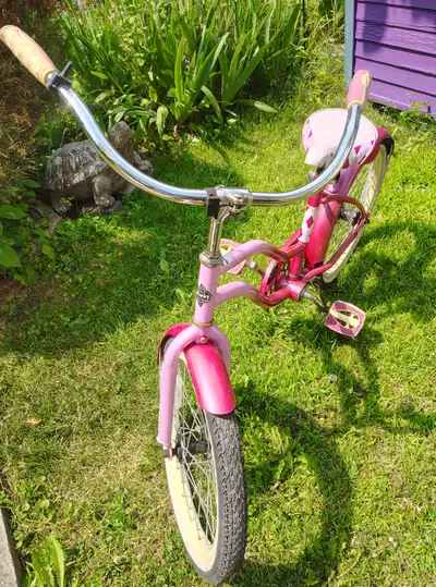 This pre-loved Garneau kids bicycle is ready for new adventures, featuring a vibrant pink frame and...