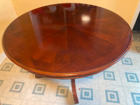large round wooden table with chairs