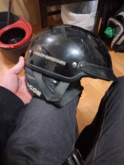 This is a black Harley-Davidson motorcycle helmet, perfect for any rider looking for a bit of classi...
